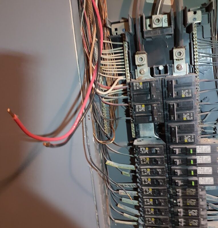 An up close image of a circuit breaker panel, highlighting the intricate network of wires and cables ideal for a panel job